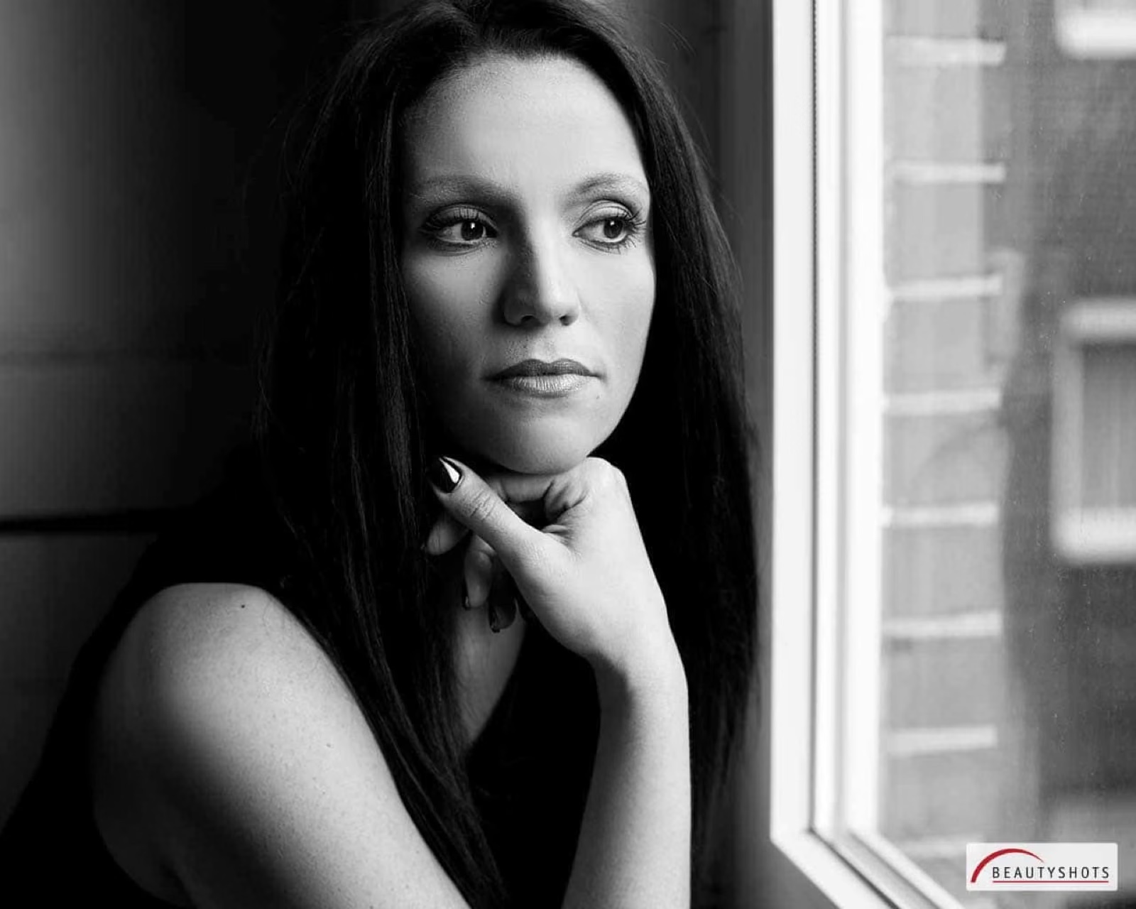 Frau am Fenster im weichen Licht – zeitloses Beauty Shooting