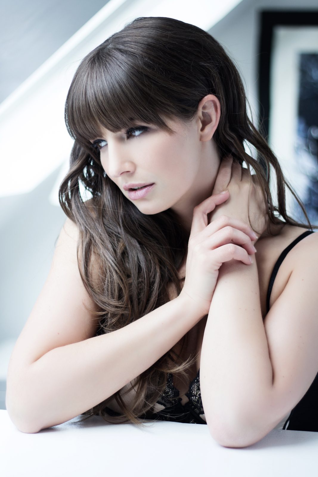 Portrait of a woman with long hair in a black lace top in a Hamburg photo studio