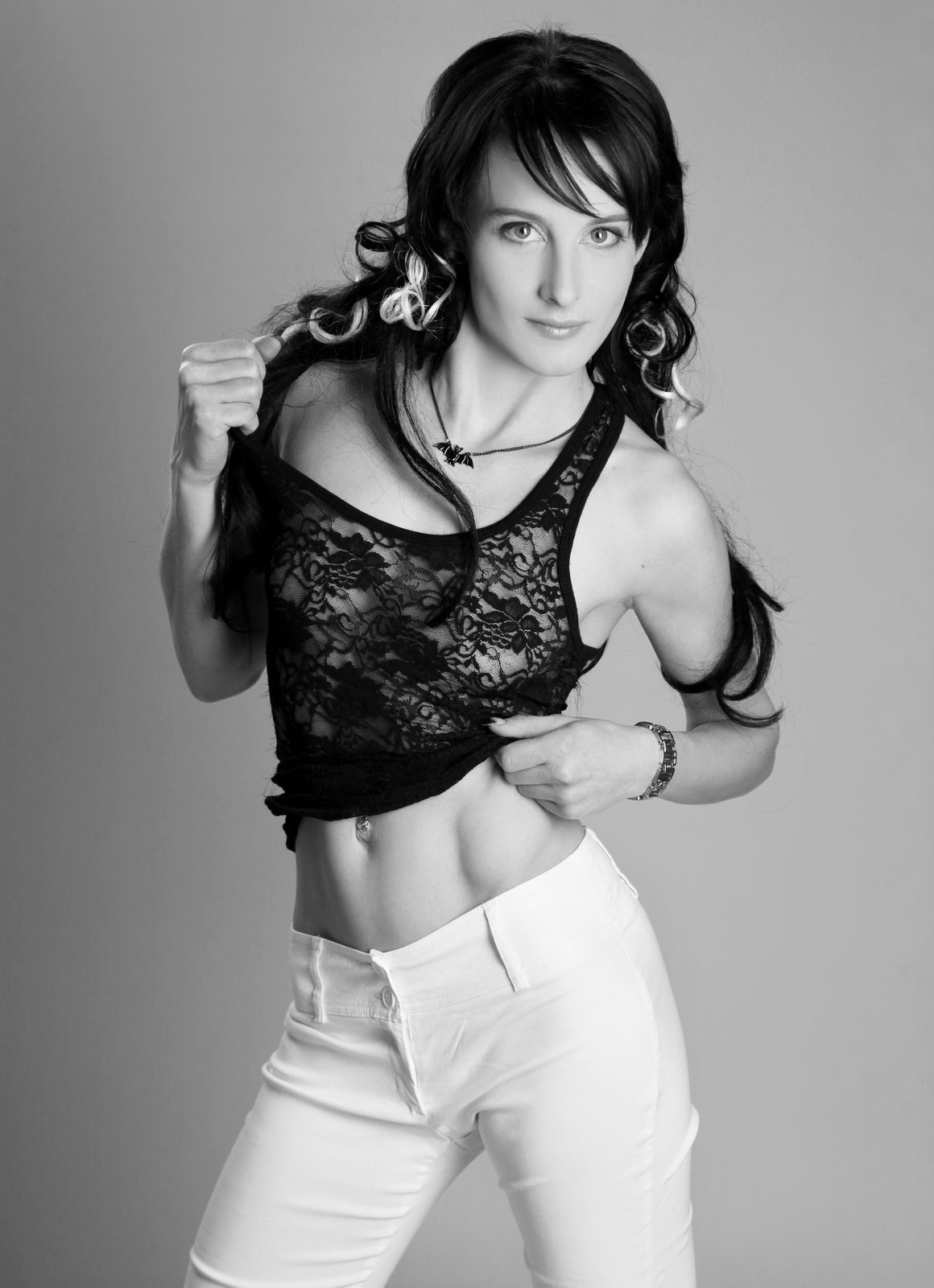 Woman in lace top posing playfully in a Hamburg photo studio