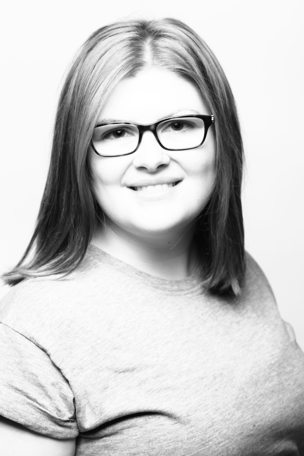 Smiling woman with glasses—black and white portrait