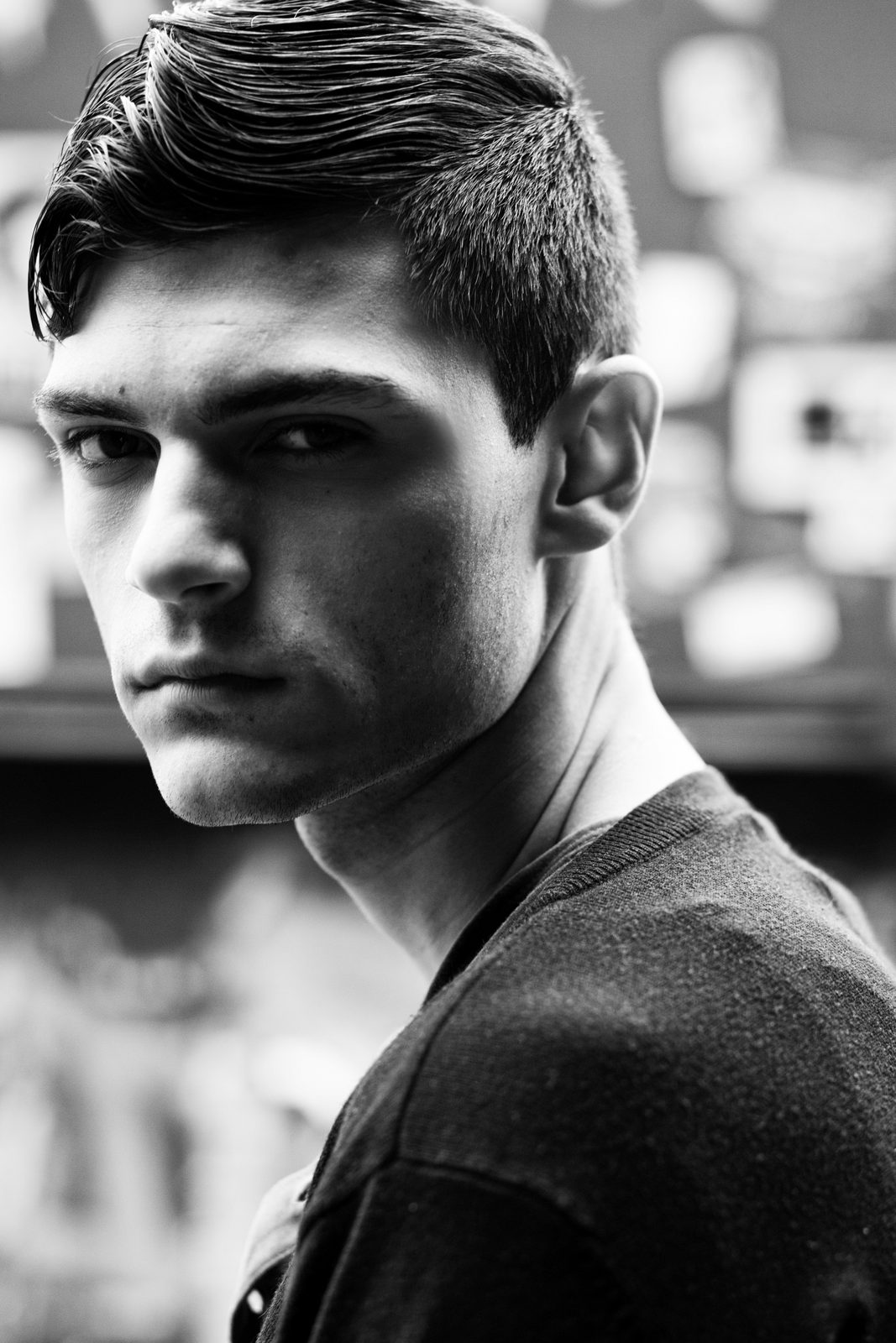 Black-and-white portrait of a young man with styled hair